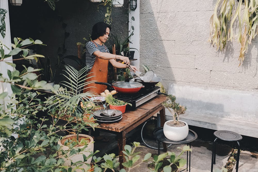 a man cooking something outside